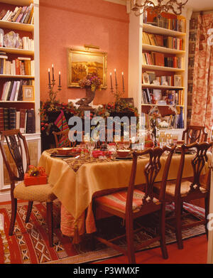 Tabelle für Weihnachtsessen mit gelben Tuch in Terracotta land Esszimmer Stockfoto