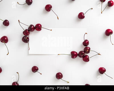 Kreatives Layout mit frischen reifen Beeren. Cherry isoliert auf weißem Hintergrund mit weißen Rechteck für Kopieren. Nutzen Sie für Ihr Design, Promo, Social Media. Ansicht von oben Stockfoto