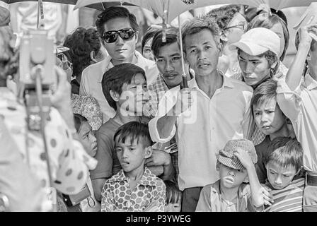 FORT SMITH, AR, USA - 10. AUGUST 1975 - eine große Menge von vietnamesischen Flüchtlingen eine Straße in Fort Chaffee, AR führen, da sie die Ankunft von Präsident Gerald R. Ford eine Begrüßung zu erwarten. Stockfoto