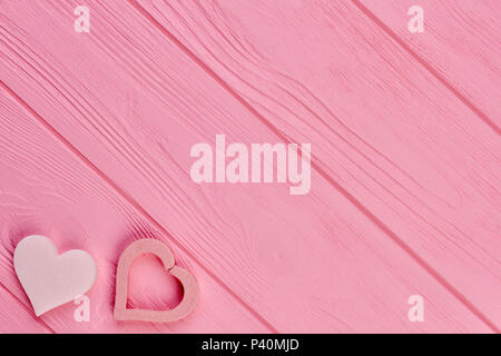 Rosa Herzen auf hölzernen strukturierten Hintergrund. Pastellfarben Herzen auf rosa Holz mit kopieren. Valentinstag Grusskarten. Stockfoto