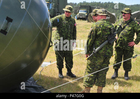 Kanadische Armee Oberst John Conrad, Links, Kommandant der Brigade 41 kanadische Gruppe und den Befehl Personal, bei Sat-Technik auf Forward Operating Base Custer, Custer, S.D., 15. Juni 2016. Die goldenen Coyote Übung ist eine dreiphasige, Szenario-driven Übung in den Black Hills von South Dakota und Wyoming, mit dem Kommandanten auf der Mission wesentliche Anforderungen der Aufgabe, Krieger Aufgaben und Übungen zu konzentrieren. (U.S. Armee Foto von SPC. Robert West/Freigegeben) Stockfoto