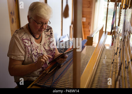 Ältere Frau mit digitalen Tablet auf Shop Stockfoto