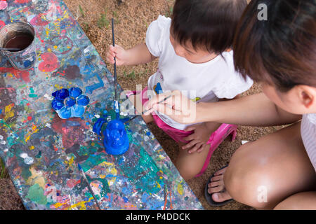 Asiatische cute girl Baby und Mutter ist Malen bunte im Park. Stockfoto