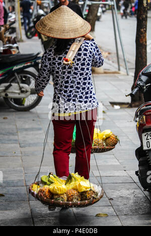 Hanoi, Vietnam - 15. März 2018: Lady verkaufen schneiden Ananas auf der Straße in Hanoi. Stockfoto