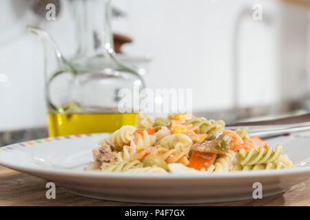 Bunte curly Makkaroni Salat mit Tomaten, surimi, Ei, Mais und Thunfisch Stockfoto