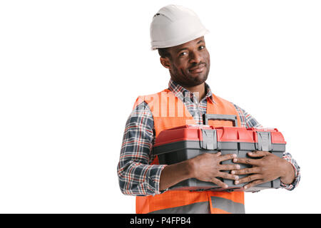 African-american Bauarbeiter mit Toolbox in den Händen isoliert auf weißem Stockfoto