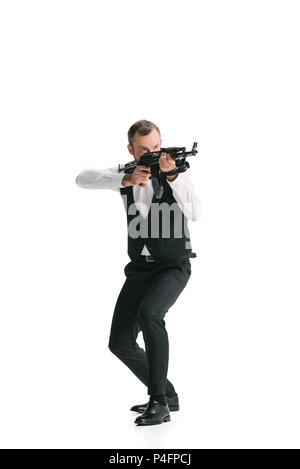 Secret Agent im Anzug mit Gewehr weg zielt auf Weiß isoliert Stockfoto