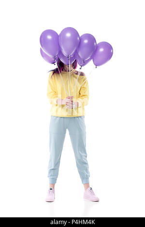 Stilvolle junge Frau mit Gesicht mit Bündel von heliumballons isoliert auf weißem Stockfoto