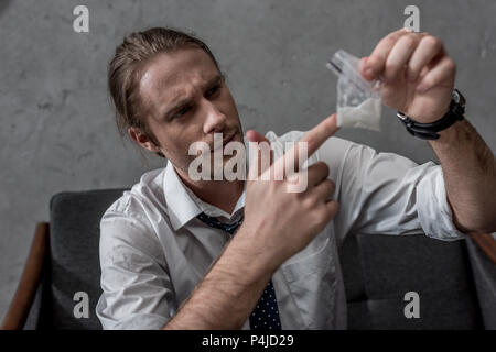 Geschäftsmann mit Drogensucht holding Pack von Kokain Stockfoto