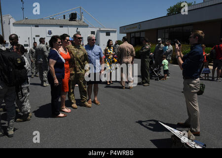 Ein Nord-carolina Air National Guard Flieger wirft mit Familienangehörigen für Foto seiner Rückkehr aus einer dreimonatigen Einsatz in Südwestasien zu feiern, während auf der North Carolina Air National Guard Base, Charlotte Douglas International Airport, 10. Mai 2017. Dies ist die erste Gruppe von Air Guard die Bereitsteller von laufenden Sendung der 145 Airlift Wing zur Unterstützung der Operation, die die Freiheit des Sentinel zurückzukehren. Stockfoto