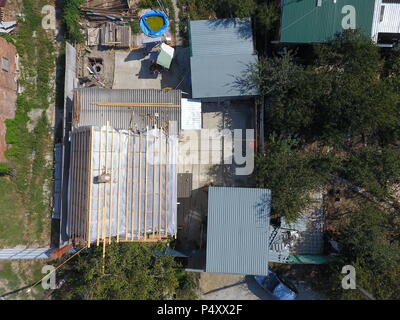 Slavjansk-auf-Kuban, Russland - 10. September 2017: Wohnhaus und Nebengebäuden. Das Dach des Hauses reparieren. Feuchtigkeit Isolierung unter Metall. Stockfoto