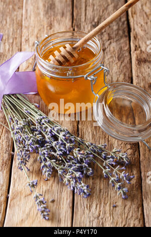 Gesunde Ernährung: floral Lavendel Honig in einem Glas close-up auf einem Tisch. Vertikale Stockfoto