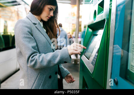 Spanien, Barcelona, Frau kauf Ticket von automatisierten Maschine am Bahnhof Stockfoto