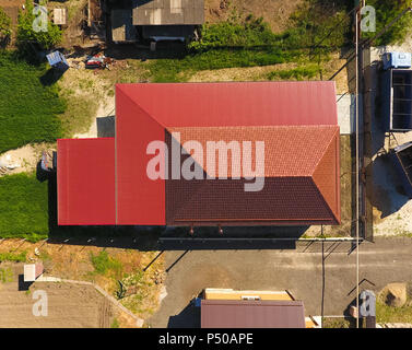 Ein Haus mit einem Baldachin über den Innenhof. Dach aus Wellblech Profil. Metall, Fliesen Stockfoto