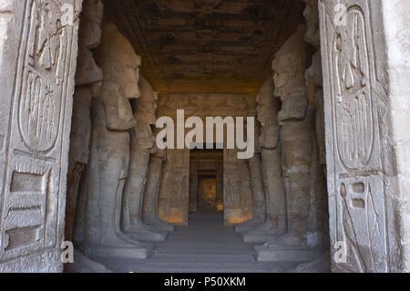 Ägyptische Kunst Großen Tempel von Ramses II (1290-1224 v. Chr.). Grabkunst Tempel in den Fels gehauen. Blick aus dem ersten Raum, mit acht Statuen von Ramses II. als der Gott Osiris. Abu Simbel. Ägypten. Stockfoto