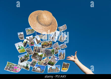 Die weibliche Hand wirft einen Strohhut, aus denen fliegen die Fotos von Sehenswürdigkeiten Amsterdams. Blue Sky ist im Hintergrund. Stockfoto