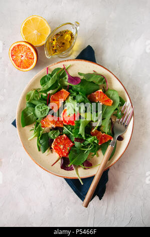 Frischer Salat Mix mit blutorangen auf einen weissen Stein Hintergrund. Gesunde Ernährung Konzept. Stockfoto