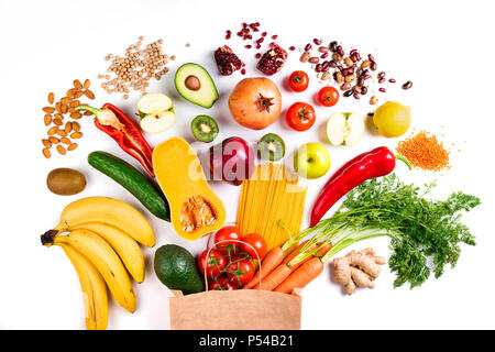 Gesundes essen Hintergrund. Gesundes Essen in Papiertüte, Pasta, Gemüse und Obst auf Weiß. Shopping, Vegetarisch, ausgewogene Ernährung Konzept. Ansicht von oben Stockfoto