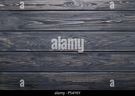 Dunkelgrauer Hintergrund der hölzernen alten rustikalen Tisch, Planken, Textur, Holz Wand. Stockfoto