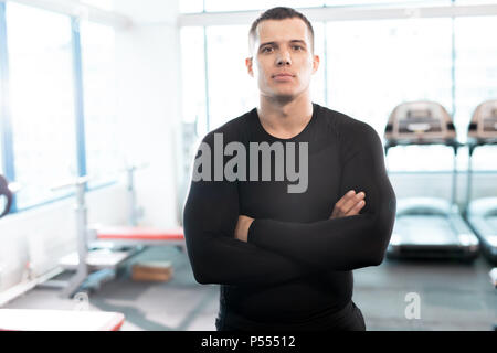 Stattliche Fitness Instructor posiert in der Turnhalle Stockfoto
