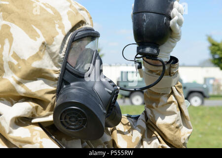 Ein Mitglied der Britischen Streitkräfte zu einem lokalen Gerät zugeordnet ist, übernimmt die grundlegenden trinken Bohrer mit Allgemein Atemschutz außerhalb der US Army Training Support Center Benelux chemischen, biologischen, radiologischen und nuklearen Einrichtung auf der Air Base Chièvres, Belgien, 09. Mai 2017. Stockfoto