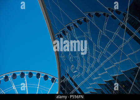 Abstrakte Sicht von Riesenrad und Spiegelungen in Glas Wand Stockfoto