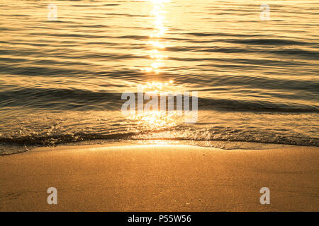 Golden Wasser am Strand im Sommer bei Sonnenaufgang Stockfoto