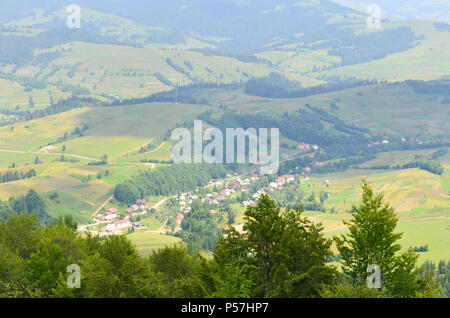 Herausragende Landschaft aus einer Höhe. Grünen Wald und Dorf in den Bergen. Ukrainischen Karpaten. Stockfoto