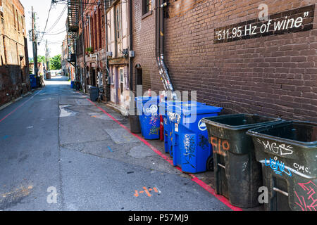 ASHEVILLE, NC, USA-24. Juni 18: Eine urbane Gasse mit Mülltonnen und ein Schild mit der Aufschrift '511.95 Hz Wein." Stockfoto