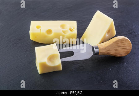 Drei Stücke Käse auf einen schwarzen Stein Schiefer Platte Stockfoto