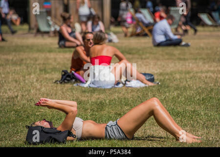 Green Park, London. 26 Jun, 2018. UK Wetter: Social Media geht auf beim Sonnenbaden - Menschen ihre Mittagspause in der warmen und sonnigen Bedingungen im Green Park genießen. Credit: Guy Bell/Alamy leben Nachrichten Stockfoto