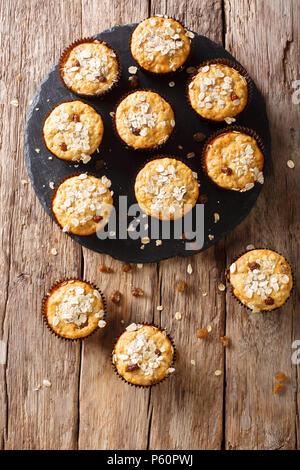 Hausgemachte Muffins von Haferflocken mit Rosinen close-up auf dem Tisch. Vertikal oben Ansicht von oben, rustikalen Stil Stockfoto