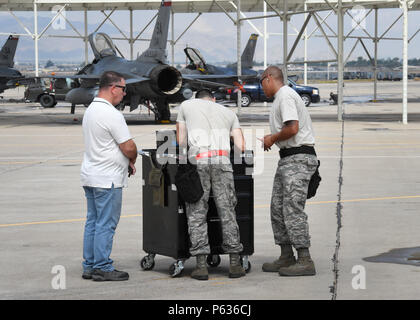 Tim Fournier (links), eine F-16 Fighting Falcon Waffen Standardisierung führen Besatzungsmitglied mit der 56 Instandhaltungsgruppe, wertet Tech. Sgt. Federico Barrios (Mitte) und Tech. Sgt. Mark Nash, Flugzeuge Rüstung Systeme Techniker, während des Ladens Teil der vierteljährlichen Last Crew der 56th Fighter Wing des Quartals Wettbewerb bei Luke Air Force Base, Arizona, April 8, 2016. Barrios und Nash sind Mitglieder von 149. der Texas Air National Guard Fighter Wing, mit Sitz in Joint Base San Antonio-Lackland, Texas, das derzeit bei Luke während der San Antonio Kelly Feld durchläuft r Stockfoto