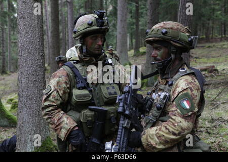 Italienische Soldaten der 5. Regiment 187. Fallschirmjäger-Regiment "Folgore" diskutieren Arbeitsabläufe während der Durchführung eines Häftlings-Exchange-Szenario während des Trainings Saber Junction 16 an der US-Armee gemeinsamen multinationalen Readiness Center (JMRC) in Hohenfels, Deutschland, 18. April 2016. Säbel Junction 16 ist der US-Army Europe 173rd Airborne Brigade Kampftraining Zentrum Zertifizierung Übung stattfindenden JMRC in Hohenfels, Deutschland, Mrz 31-Apr 24, 2016.  Die Übung soll die Bereitschaft der Armee Europa ansässigen Kampfbrigaden einheitliches Land Geschäfte bewerten eine Stockfoto