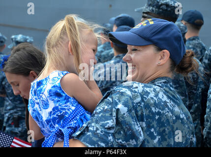 160411-N-DA 434-041 Santa Rita, Guam (11. April 2016) Rumpf Wartungstechniker 1. Klasse Rachel Reynolds, zum U-Boot Tender USS Emory S. Land zugewiesen (39), hält die Tochter eines Rückkehr shipmate beim Warten auf Sierra Pier. Die Rückkehr nach Guam ist Emory S. Land's erste seit dem Wechsel von homeport von Diego Garcia nach Guam, Dez. 23. Emory S. Land ist ein EXPEDITIONARY U-Boot Ausschreibung Durchführung von koordinierten neigten, Liegeplätze und flott Wartung in den USA 5. und 7 Flotte Bereiche. (U.S. Marine Foto von Massenkommunikation Seaman Apprentice Alana Langdon/Freigegeben) Stockfoto