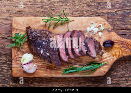 Scheiben von Einems gegrilleten Steak in Holz Stockfoto