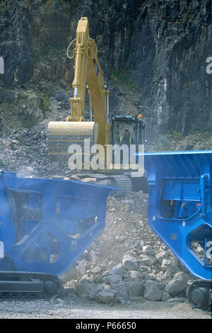 Zwei große Raupenschlepper crushing Felsen in einem Steinbruch, Pennines, England Stockfoto