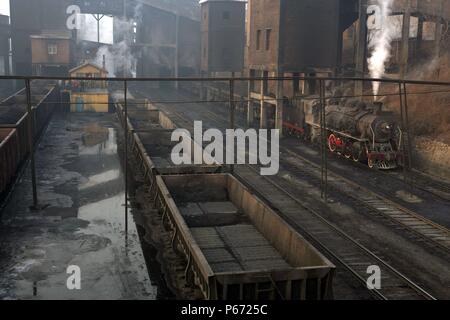 Ein Rake von Raub Wagen warten hinter einem Chinesischen SY klasse Mikado an Beichang Wäsche im November 2006 geladen werden. Stockfoto