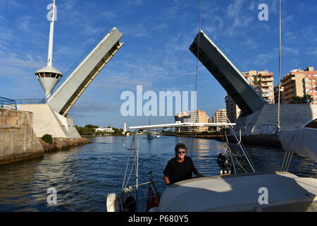 Boot vorbei unter dem Estacio anheben Brücke, die den wichtigsten Kanal zwischen dem Mittelmeer und dem Mar Menor, La Manga del Mar Menor, Murcia, Spanien Kreuze Stockfoto