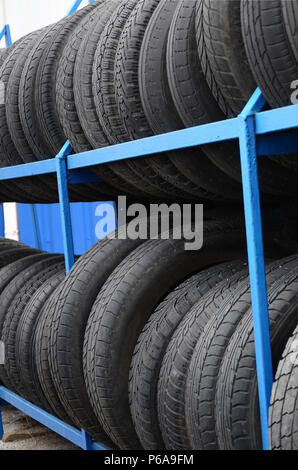 Rack mit Vielzahl von Autoreifen in Automobil speichern. Viele schwarze Reifen. Reifen Hintergrund stack. Selektive konzentrieren. Stockfoto