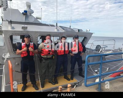 Die United States Coast Guard Station Manistee ist eine Such- und Rettungseinheit der Great Lakes in Michigan. Das Archivbild dokumentiert Besatzungsmitglieder und den Deputy eines County Sheriffs an Bord eines 45-Fuß-Response Boat-Medium auf dem Lake Michigan, nachdem am 23. Juni 2018 eine hypotherme Person gerettet wurde. Stockfoto