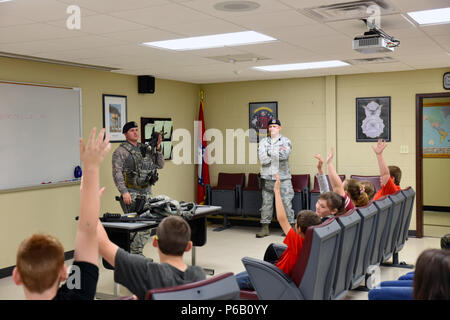 Staff Sgt. Cameron Lebarr, 188 Sicherheitskräfte Squadron Mitglied, zeigt Studenten aus Mansfield Grundschule Werkzeuge und Waffen, mit der die 188 SFS verwendet. April 20, 2016, während Ihrer Tour bei Ebbe Air National Guard Base, Fort Smith, Arche. Die Studierenden wurden gezeigt, Karrieren im Tiefbau, in der Ferne pilotengesteuerte Flugzeug- und Sicherheitskräfte. (U.S. Air National Guard Foto von älteren Flieger Cody Martin/Freigegeben) Stockfoto