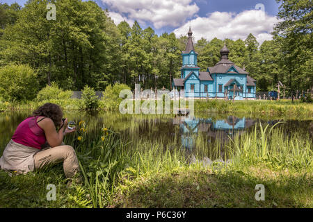 Eine Frau nimmt Bild von Blau, Holz- orthodoxen Kirche. Podlachien. Podlachia. Polen, Europa. Die Region wird als Podlasko oder Podlasze Stockfoto