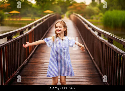 Kleine Mädchen spielen im Freien unter Sommer Regen Stockfoto