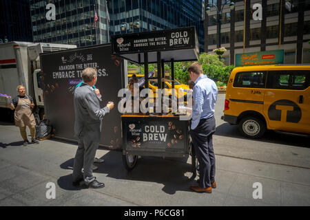 Arbeitnehmer Mann eine Karre auf der Park Avenue in New York, die Proben der Nestlé Coffee-Mate Marke natürlichen Glückseligkeit kalten Kaffee brühen, bei einem Branding Event am Dienstag, 26. Juni 2018. (Â© Richard B. Levine) Stockfoto