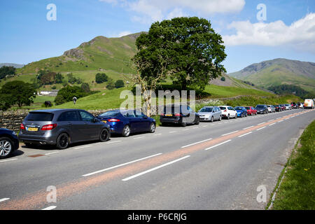 Wanderer Autos in Layby auf der a591 Road in der Nähe von Felder und Hügel in der Nähe von Grasmere im Lake District, Cumbria England uk geparkt Stockfoto