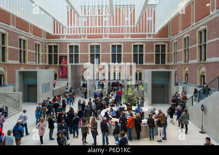 Amsterdam, Niederlande - Mai 2018: Besucher in der modernen Halle im neuen Atrium des Rijksmuseum. Eingang zum Museum, massive Decke Dekorationen und Leute in Holland National Museum. Stockfoto