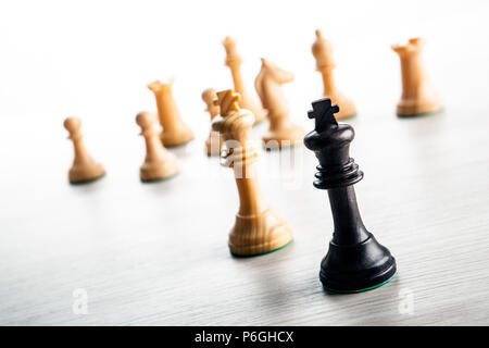 Schachfiguren auf einem grauen Hintergrund mit schwarzen und weißen Schach Könige Nahaufnahme Stockfoto
