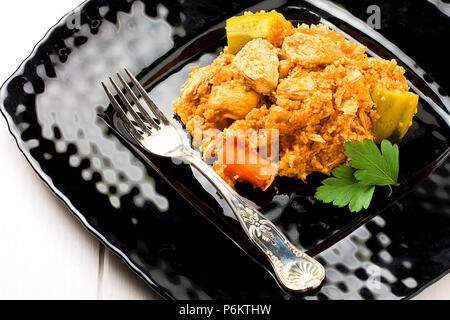 Couscous auf Schwarz und Silber Gabel auf weiße Holztisch Stockfoto