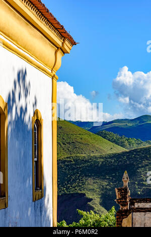 Seitenansicht von der alten Kirche in kolonialer Architektur in der Stadt Ouro Preto mit seinen Bergen und Horizont im Hintergrund Stockfoto